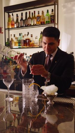 Bartender preparing a cocktail at the fine dining restaurant Daniel, known for its upper east side French cuisine.